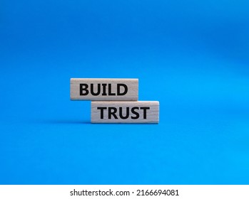 Build trust symbol. Wooden blocks with words Build trust. Beautiful blue background. Business and Build trust concept. Copy space. Conceptual image