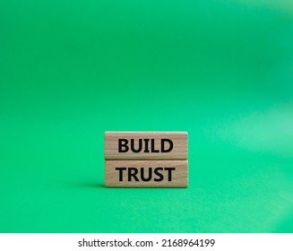 Build trust symbol. Wooden blocks with words Build trust. Beautiful green background. Business and Build trust concept. Copy space.