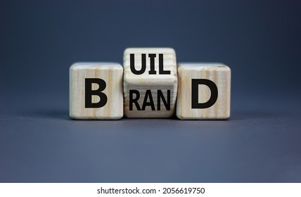 Build your brand symbol. Turned wooden cubes and changed the word 'build' to 'brand'. Beautiful grey background. Build your brand and business concept. Copy space. - Shutterstock ID 2056619750
