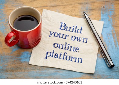 Build your own online platform advice - handwriting on a napkin with a cup of espresso coffee - Shutterstock ID 594240101
