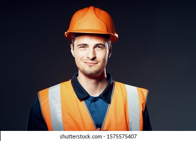 Builder architect with orange helmet and reflective vest