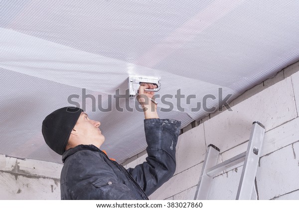 Builder Attaches Vapor Barrier Wooden Beams Stock Photo