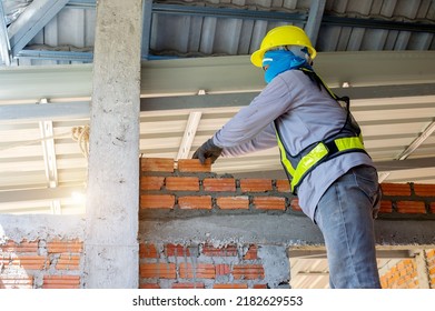 Builder Carefully Puts Red Brick On The Masonry. Quick Work Bricklayer. Guy Measures Level Masonry. Man Is Building Brick Wall. Correctly Calculate Material. Builder Manually Carries Brick Structure,B