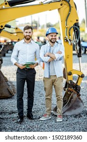 Builder Choosing Heavy Machinery For Construction, Talking With A Sales Consultant On The Open Ground Of A Shop With Special Vehicles