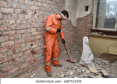 Builder cleaning apartment after demolition jobs.