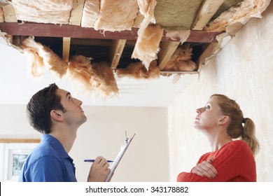 Builder And Client Inspecting Roof Damage
