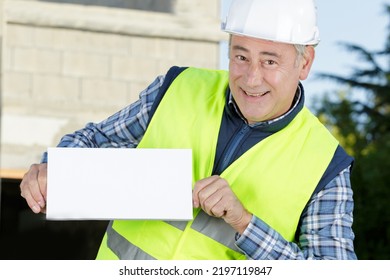 Builder Construction Worker Is Holding A Draft Document