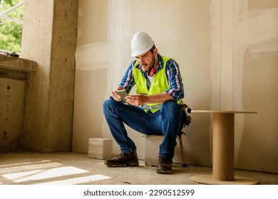 Builder or contractor using a mobile phone on construction site.