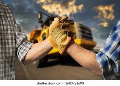 Builder Or Engineer Handshake On The Construction Background