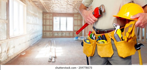 Builder handyman with construction tools. House renovation background. - Shutterstock ID 259778573
