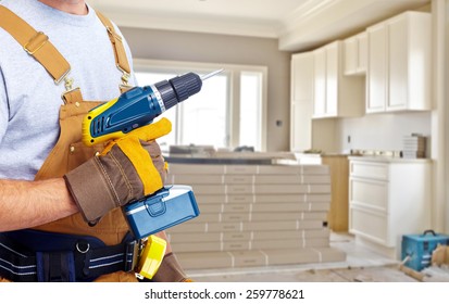 Builder Handyman With Construction Tools. House Renovation Background.