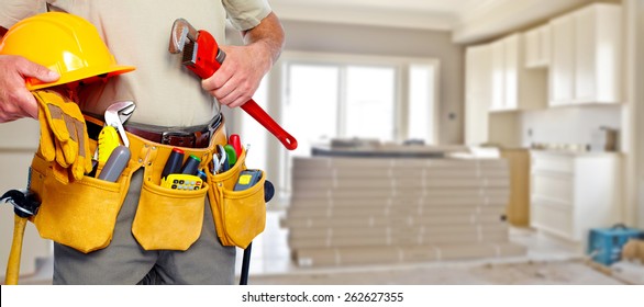 Builder Handyman With Construction Tools. House Renovation Background.