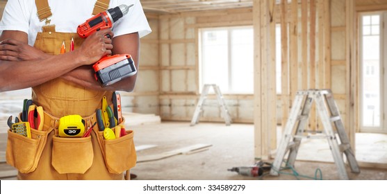 Builder Handyman With Construction Tools. House Renovation Background.