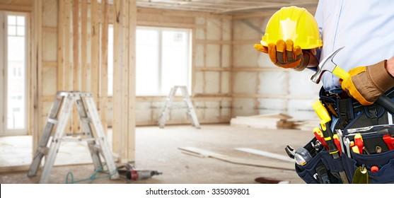 Builder Handyman With Construction Tools. House Renovation Background.