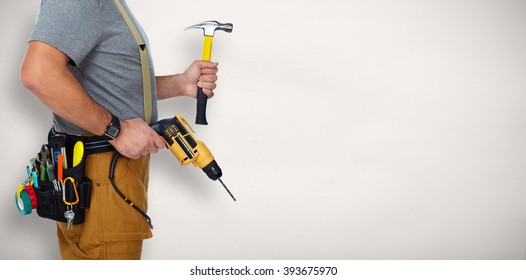 Builder handyman with drill and hammer.