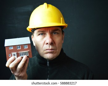 Builder in hardhat with house