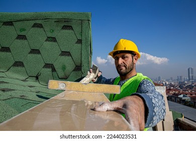 The builder is hitting the marble with a hammer and leveling it with a spirit level. The master replaces a polished marble handrail. - Shutterstock ID 2244023531