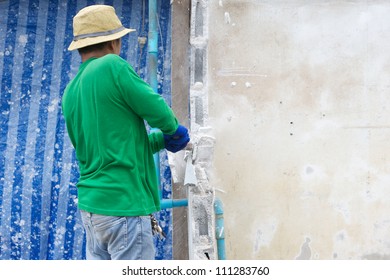 Builder Hitting A Wall With A Sledge Hammer