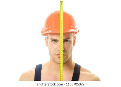 Builder. Industrial worker. Mechanic in construction helmet holds construction ruler near face. Man with construction roulette. Engineer in construction helmet with tape measure. Isolated. Close Up. - Powered by Shutterstock