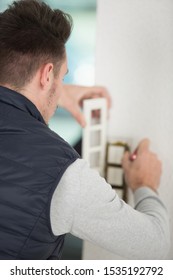 builder installing a triple lightswitch