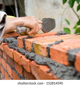 Builder Laying Bricks In Site.