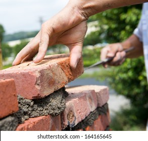 Builder Laying Bricks In Site.