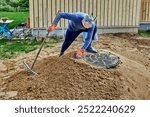 Builder made mound of sand around part of concrete ring of septic tank that protrudes above ground.