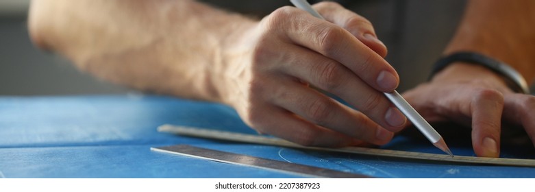 Builder Man Hand Holding Pencil And Make Corrections On Building Plan