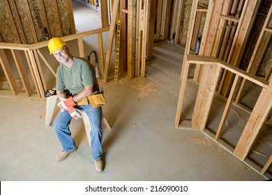 Builder on site in hardhat, smiling, portrait, elevated view