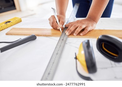 Builder, planning and blueprint with ruler and measure for engineering and architect floor plan. Working, tools and construction job at company with drawing of home renovation with person at office - Powered by Shutterstock