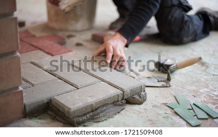 builder puts tiles in the yard. Paving slab. DIY home improvement.
