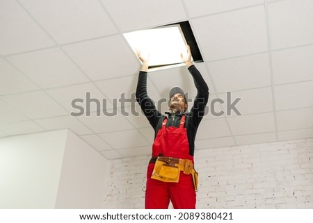 Builder replacing ceiling panel, working, ceiling armstrong
