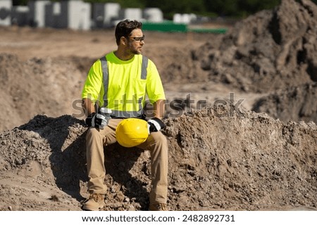 Builder rest. Construction worker with hardhat helmet on construction site. Engineer worker in builder uniform. Portrait of builder ready to build new house. Worker in hardhat at construction site.