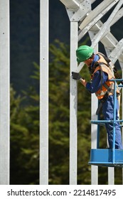 A Builder Secures Framing In A Huge Tunnerl House That Will Become A Herd Home For Dairy Cows, West Coast, New Zealand