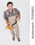 Builder smiling with tools.