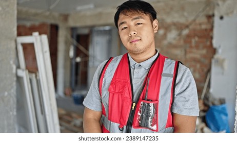  builder standing with serious expression at construction site