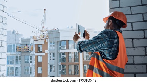 Builder Taking Photo With Digital Tablet On Construction Site