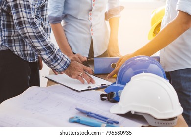 Builder Team Meeting And Planning For Renovation Office Project. Worker Contractor Talking With Architect And Discussing About Job.