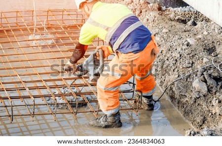 Builder using electric braker fot breaking concrete from the top of pile to fit reinforcement cage on top of it