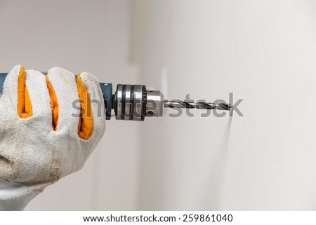 Builder or worker drilling with a machine or drill