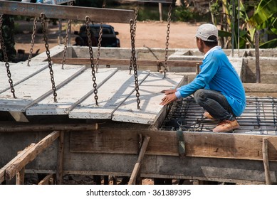 Builder worker man installing cement floor slab panel at building construction site