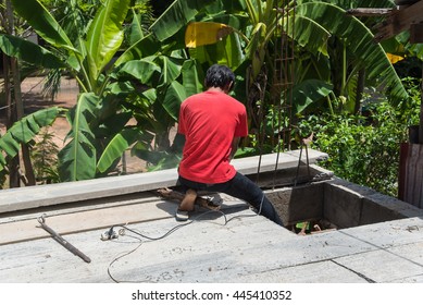 Builder worker man installing cement floor slab panel at building construction site