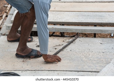 Builder worker man installing cement floor slab panel at building construction site
