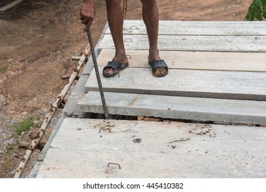Builder worker man installing cement floor slab panel at building construction site