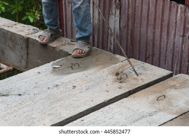 Builder worker man installing cement floor slab panel at building construction site