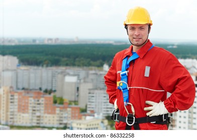 Builder Worker In Uniform With Safety Belt At Construction Site