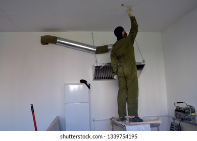builder in working form. man with a red beard in a room with white walls. putty ceiling