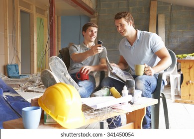 Builders Relaxing During Break On Site