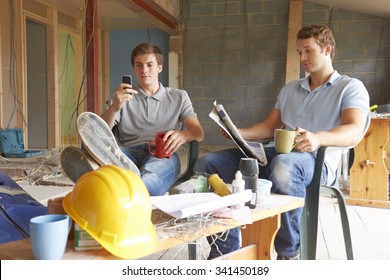 Builders Relaxing During Break On Site