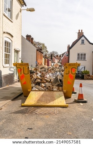 A builders skip containing rubble and bricks from a ongoing home renovation